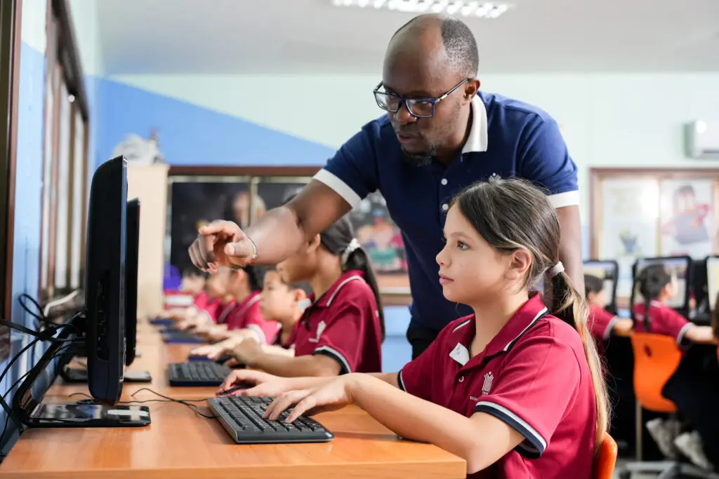 Wichai Wittaya primary student receiving guidance in the computer lab